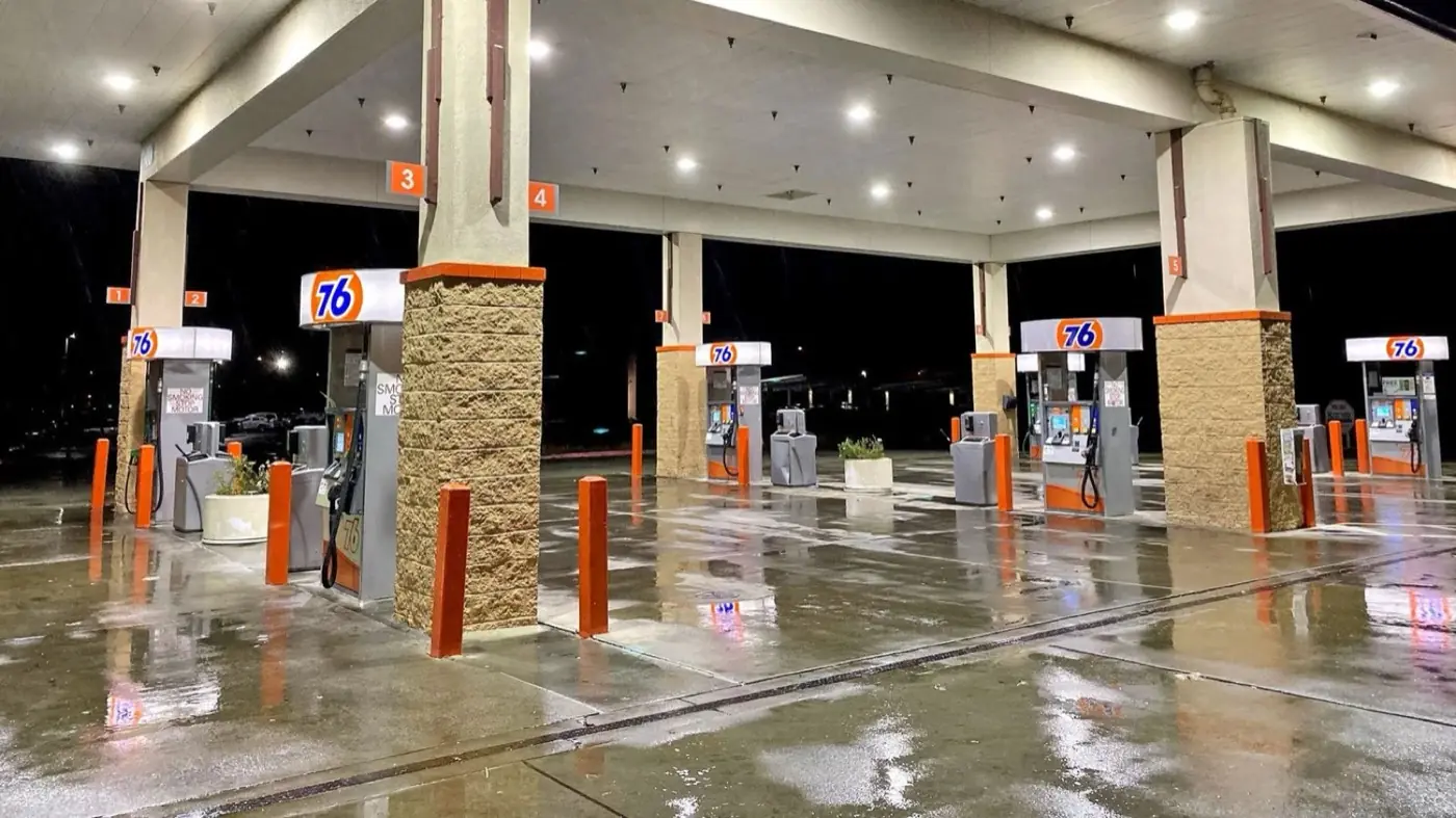 Freshly cleaned gas station pavement at night